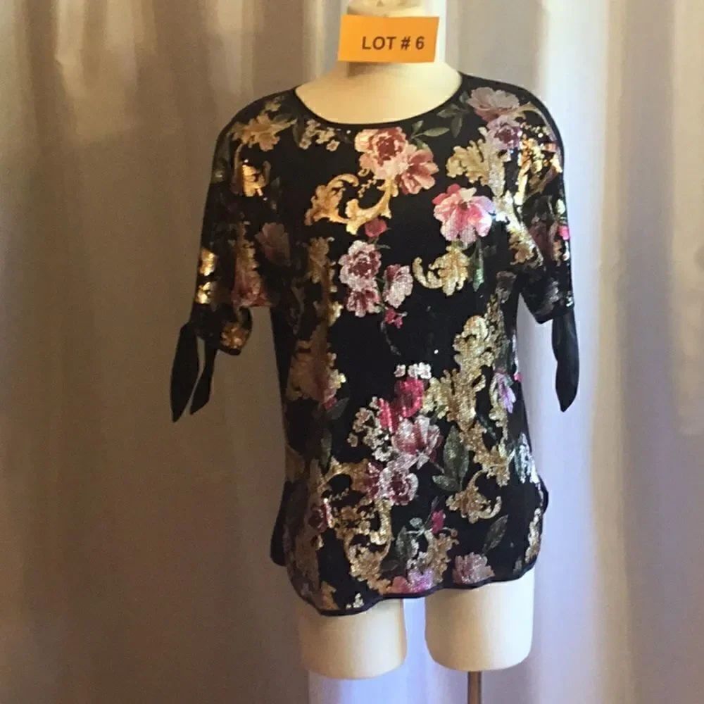Sequined front ladies top with peek a boo sleeves that tie in size med.